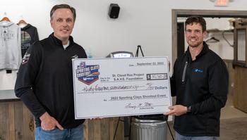 photo of Scott Schreiner and Greg Roth holding a check