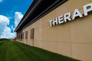 Wide shot of Twin Cities Orthopedics with blue sky