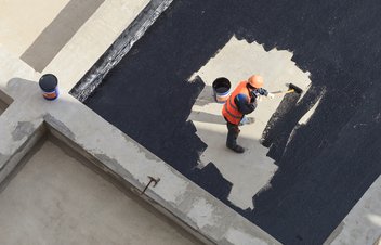 worker applied waterproofing to a surface