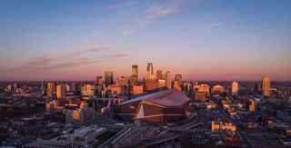 aerial view of US bank Stadium with minneapolis skyline behind