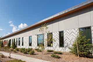 photo of the imprinted feather design on the side of the community center