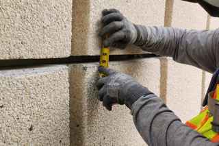 wells worker measuring for restoration