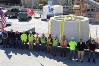 gate veterans standing in front of portions of the columns before shipment