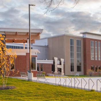 Wide shot of Hutchinson High School with a cloudy sky in the background