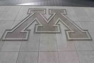 university of minnesota logo engraved on wall panels