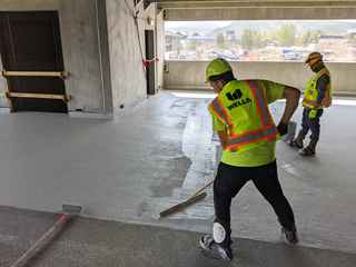 wells sealants and restoration team applying a new traffic coating in a parking garage