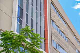 Photo of a prefabricated concrete building with tree in front