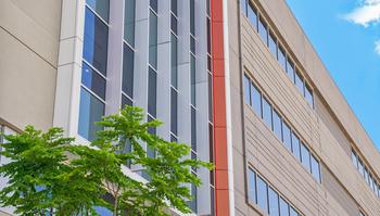 Photo of a prefabricated concrete building with tree in front