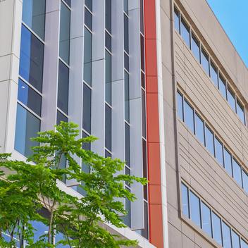 Photo of a prefabricated concrete building with tree in front