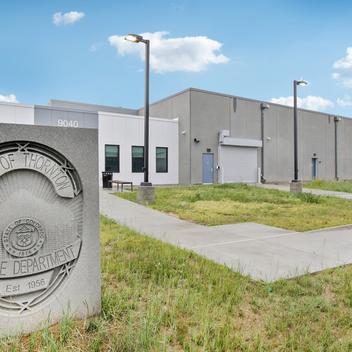 exterior of thornton police shooting range with badge sign