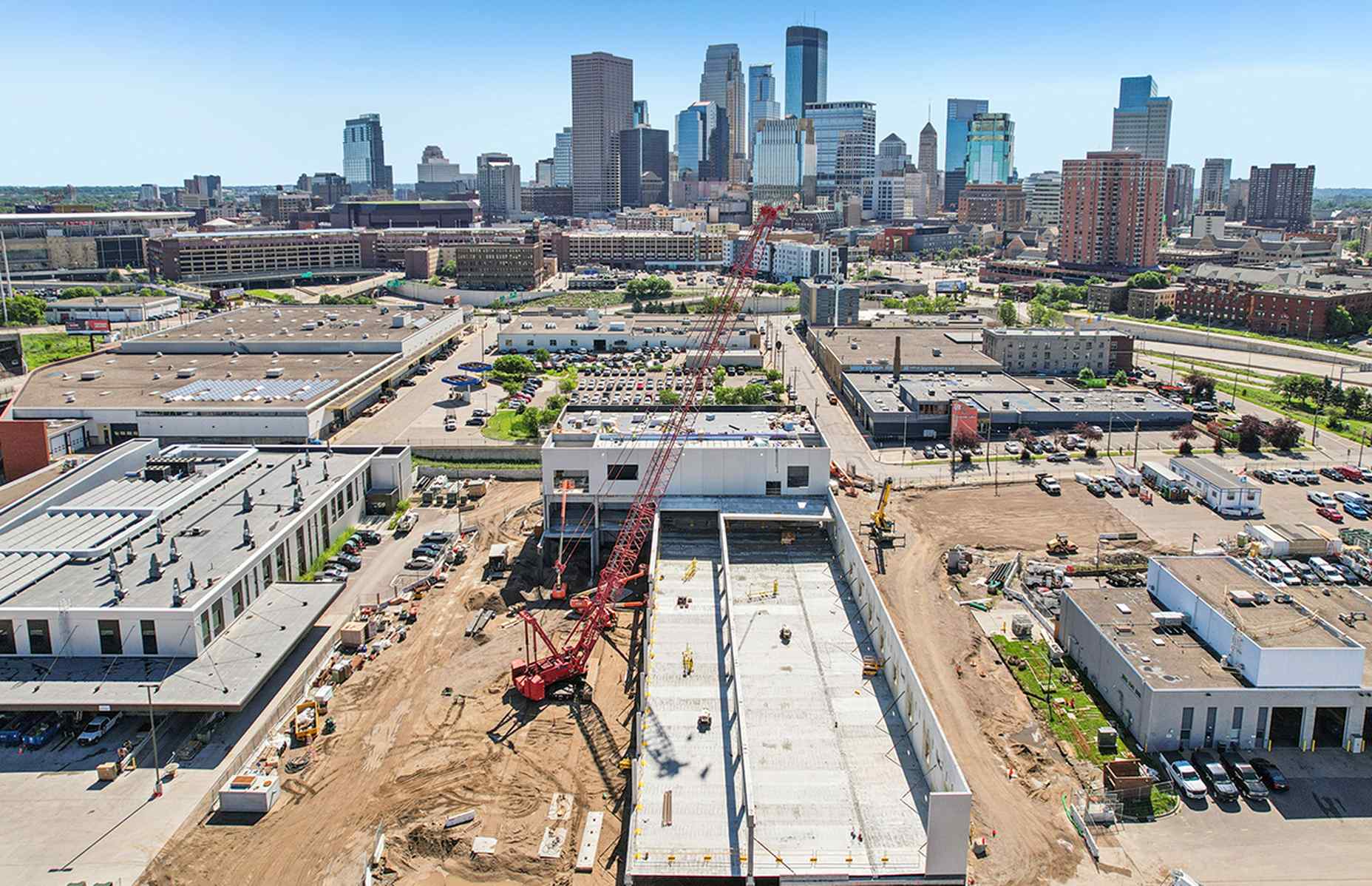 aerial of service center construction with city in back