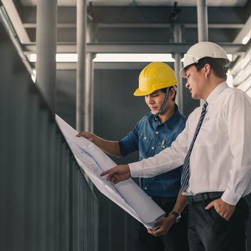 Two engineers talking about a drawing